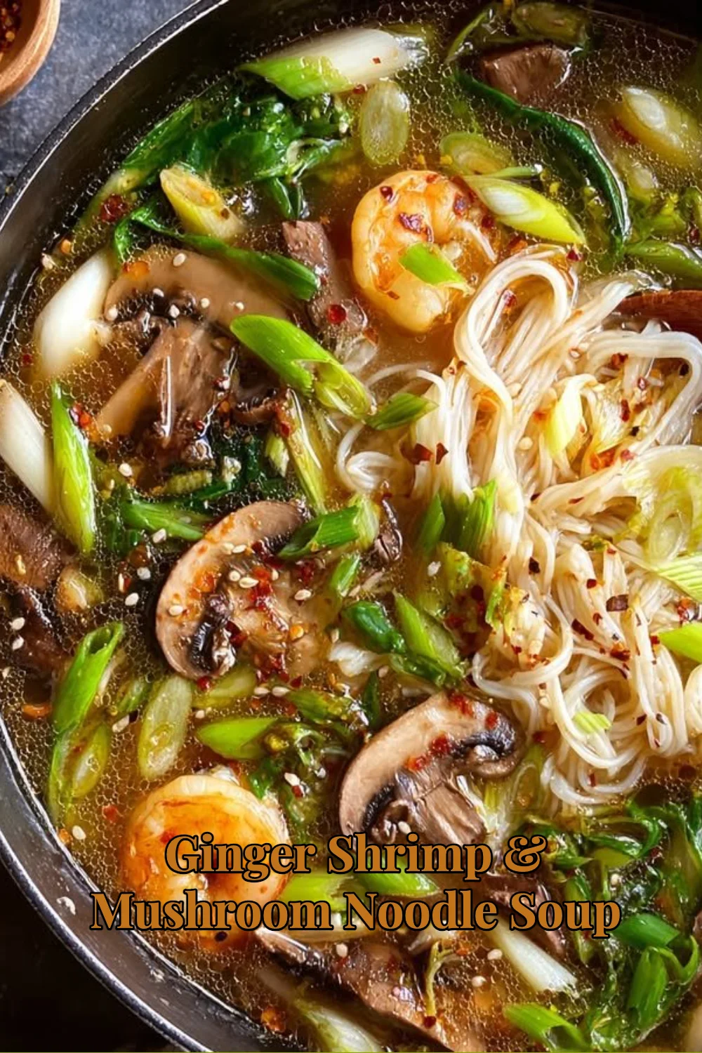 Bowl of warm Ginger Shrimp & Mushroom Noodle Soup with fresh ingredients