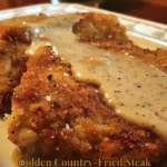 Golden Country-Fried Steak served with homestyle gravy on a plate