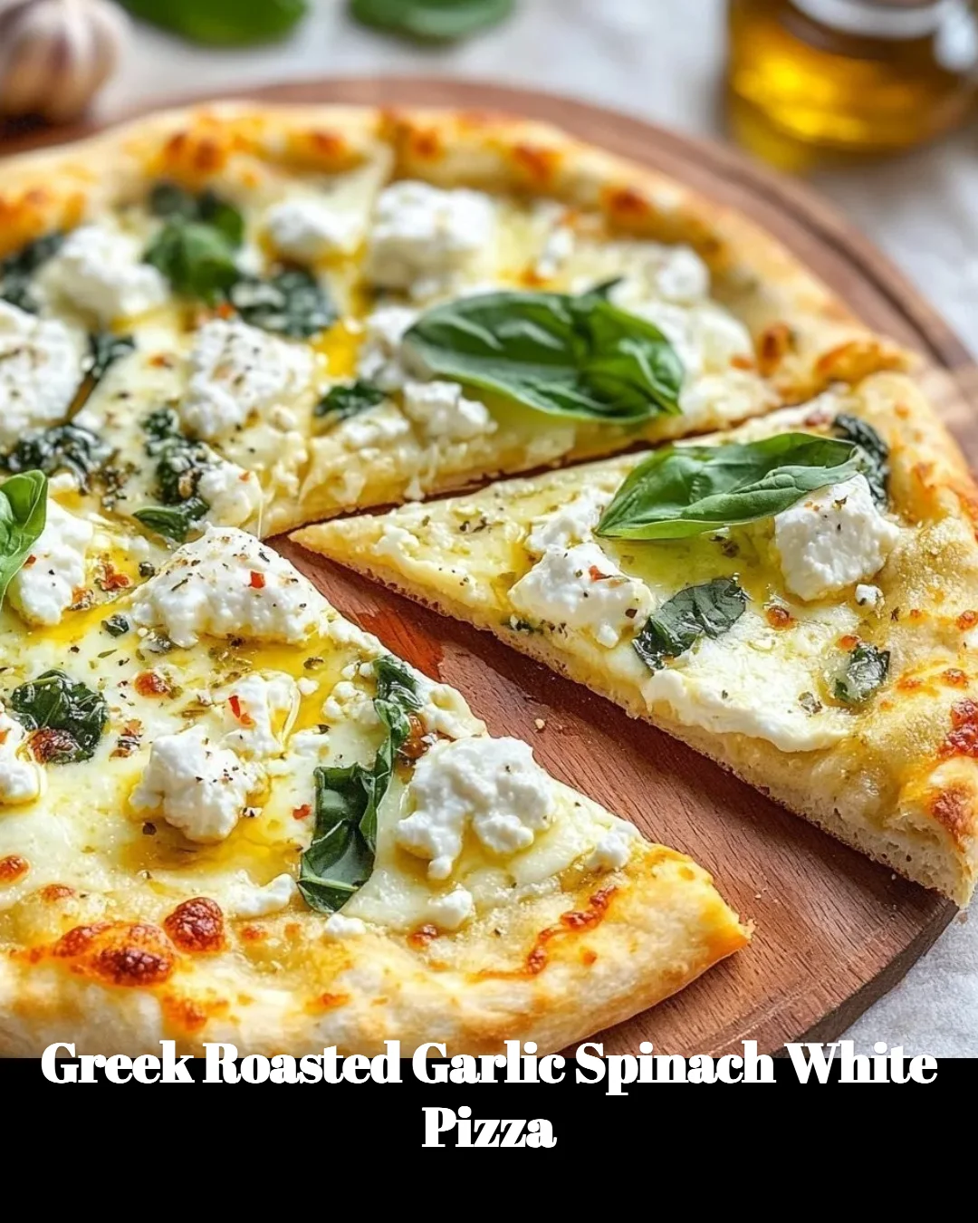 Greek roasted garlic spinach white pizza topped with fresh ingredients.