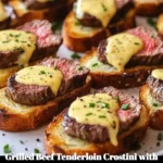 Grilled beef tenderloin crostini with béarnaise sauce on a platter