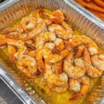 Delicious Henny Butter Shrimp served with herbs and spices.