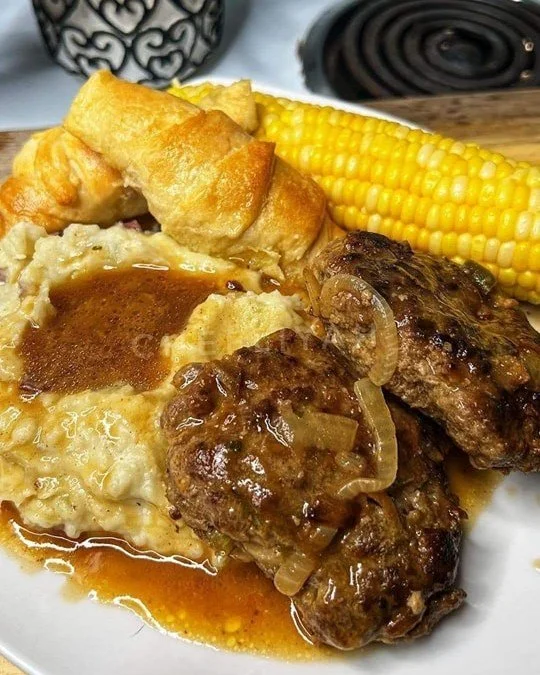 Homemade Salisbury steak with rich gravy and sautéed vegetables
