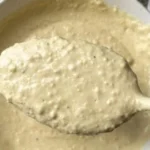 Bottle of Johnny B's Caesar Dressing with fresh ingredients