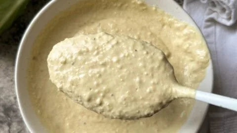 Bottle of Johnny B's Caesar Dressing with fresh ingredients