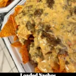 Delicious loaded nachos topped with cheese, jalapeños, and guacamole.