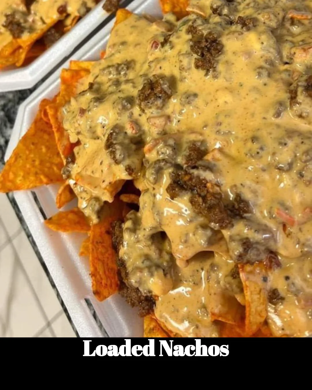 Delicious loaded nachos topped with cheese, jalapeños, and guacamole.