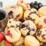 Delicious mini pancake muffins served on a plate with syrup and butter