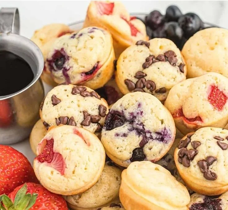 Delicious mini pancake muffins served on a plate with syrup and butter