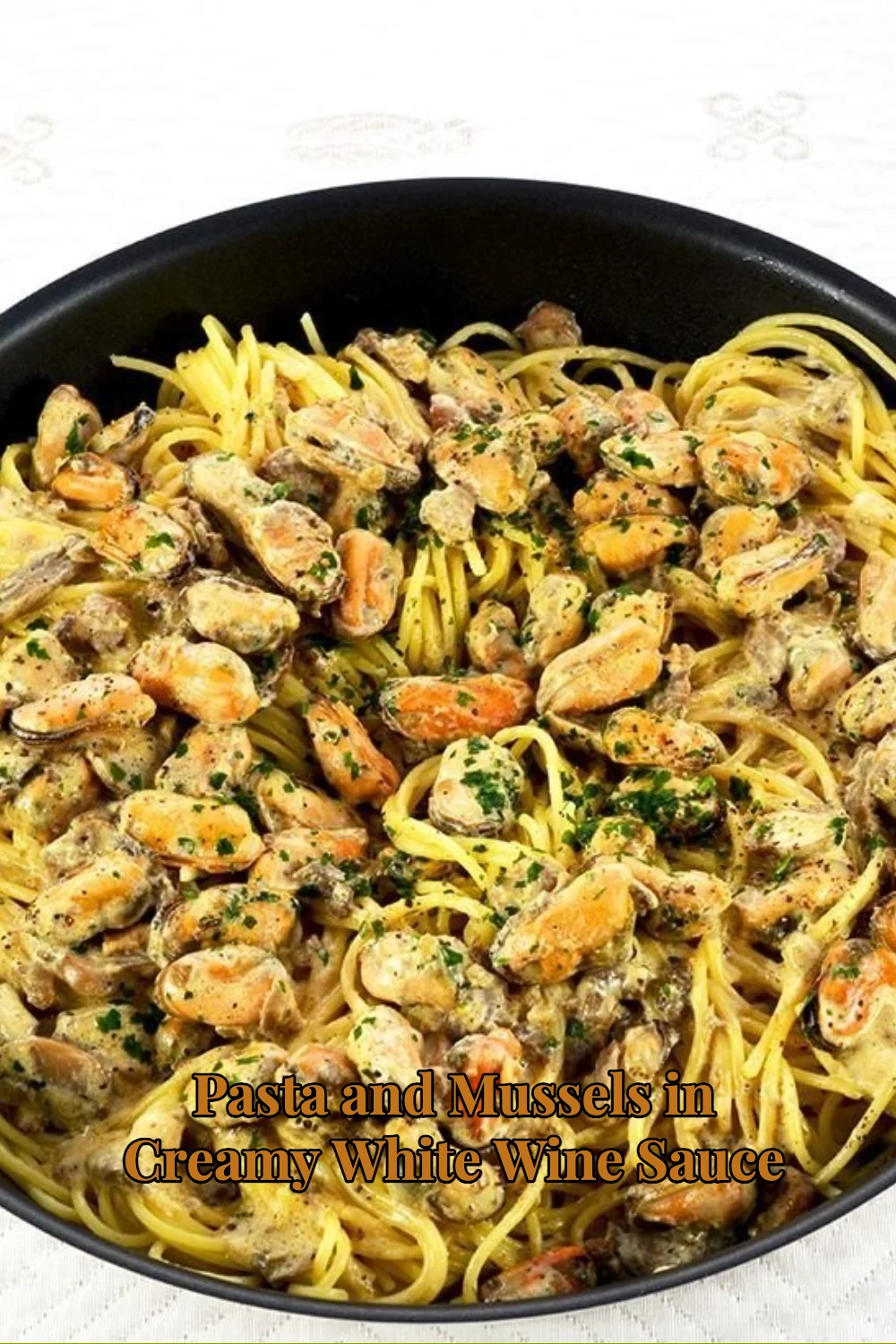 Pasta and mussels in creamy white wine sauce served in a bowl