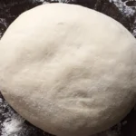 An image of fresh pizza dough ready to be shaped and baked.