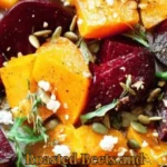 A colorful dish of roasted beets and butternut squash served on a plate.