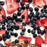 Sheet pan fruit pizza topped with colorful fresh fruits and cream cheese frosting