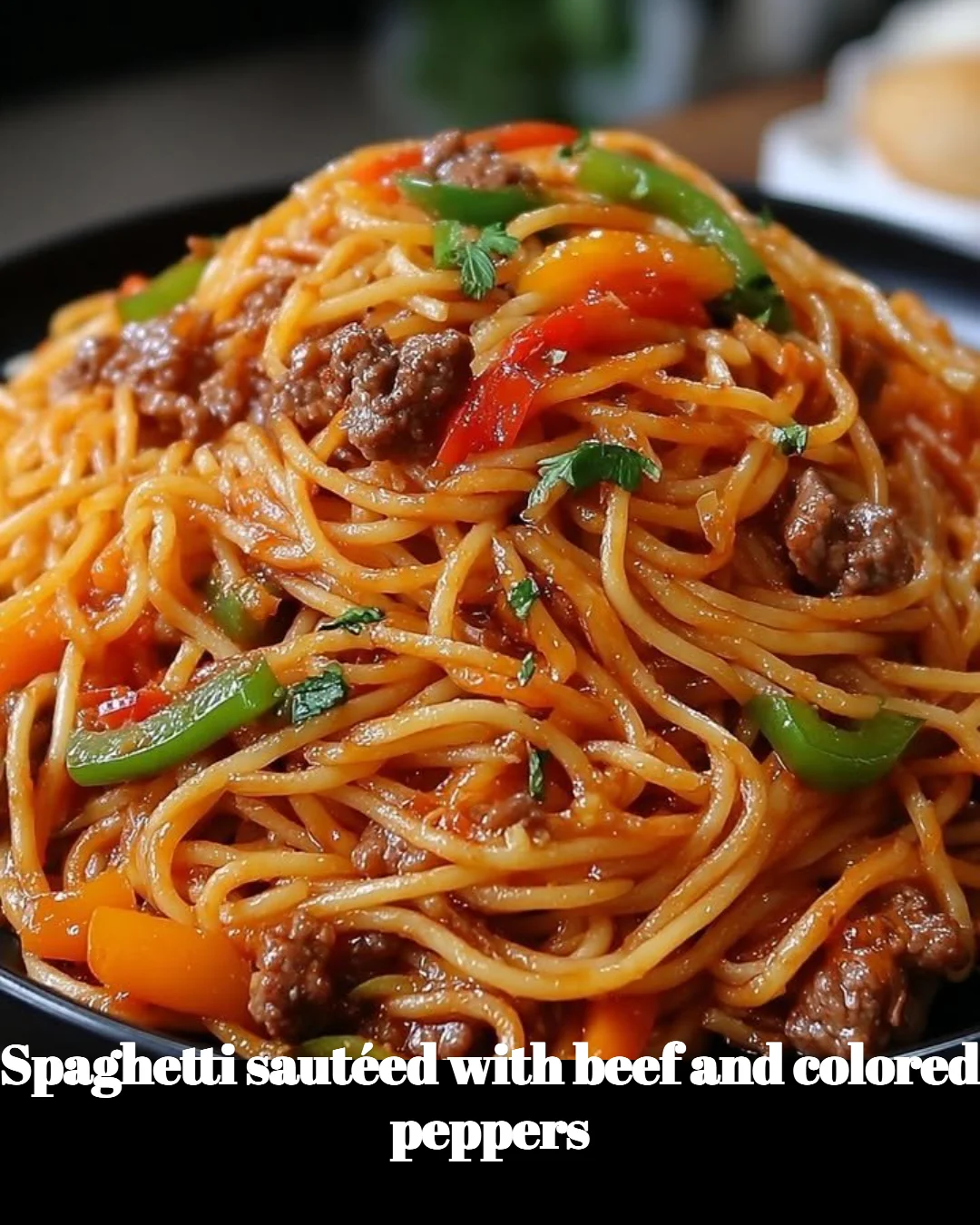 Plate of spaghetti beef sautéed with colorful peppers, a delightful and savory dish.