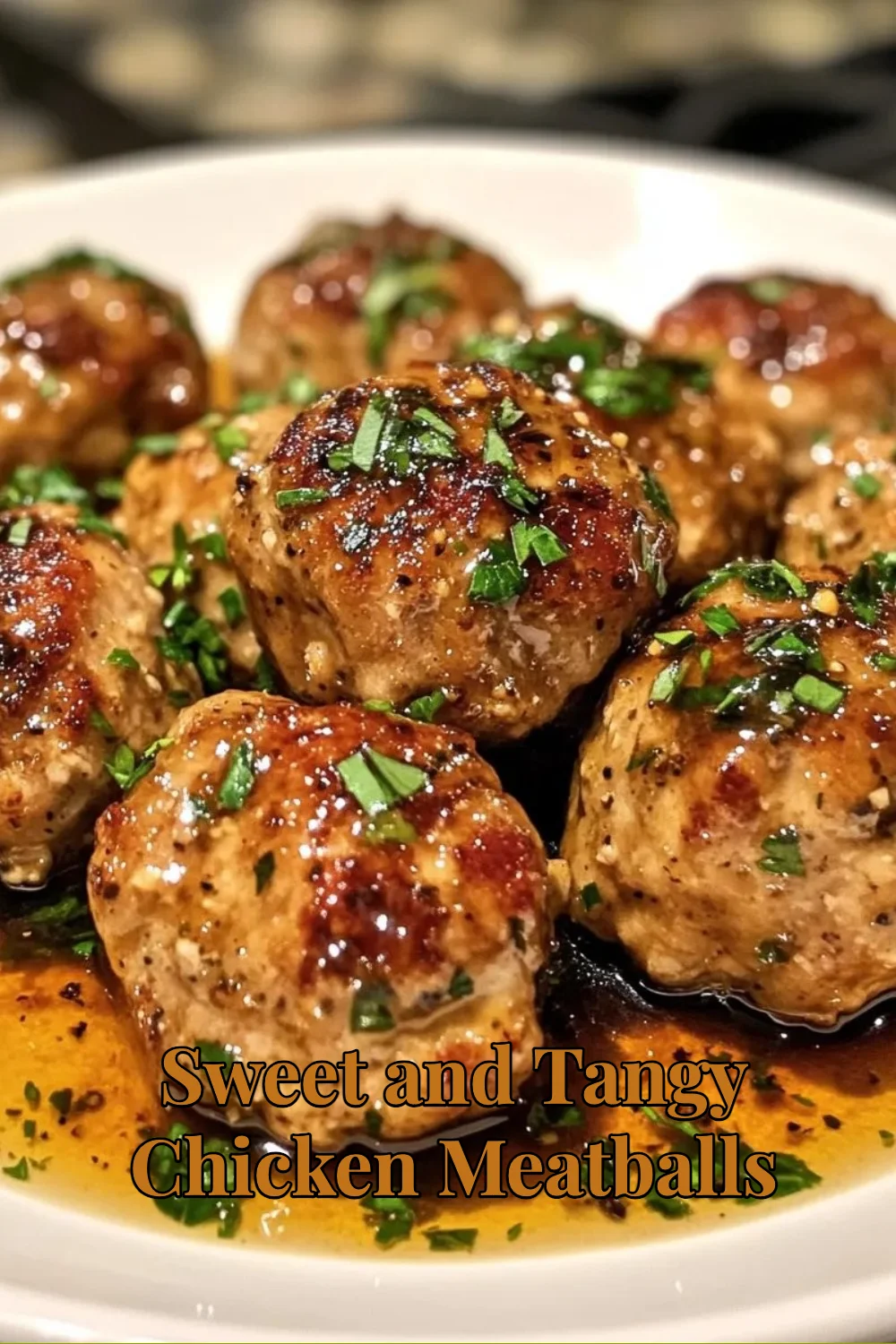 Sweet and tangy chicken meatballs served on a plate with garnish.