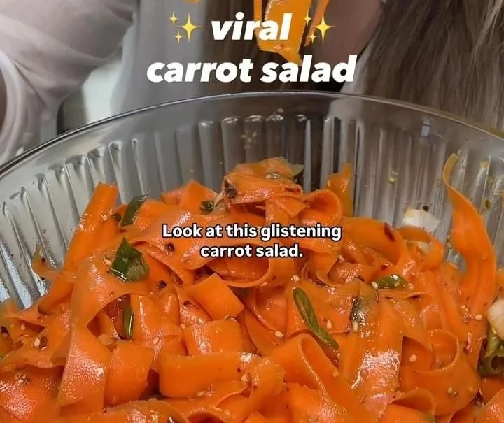 Viral carrot salad with colorful ingredients and dressing served in a bowl
