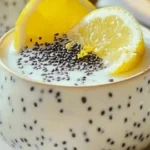 Zesty lemon chia seed pudding served in a clear glass with fresh lemon slices