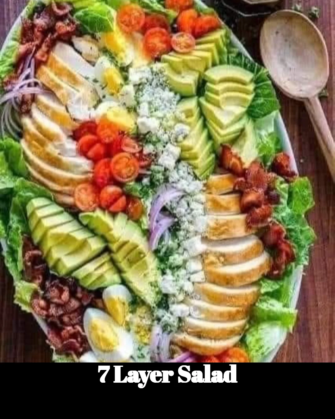 Colorful and delicious 7 Layer Salad in a glass bowl, showcasing layers of fresh ingredients.