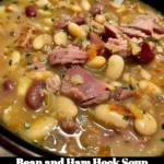A bowl of delicious Bean and Ham Hock Soup garnished with herbs