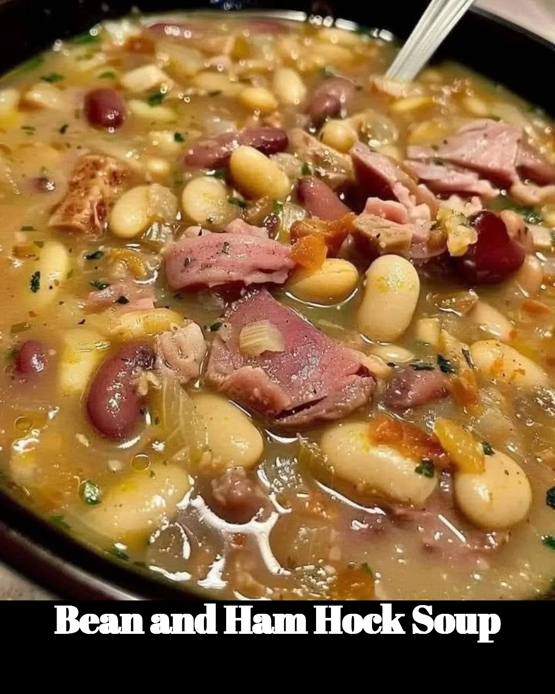 A bowl of delicious Bean and Ham Hock Soup garnished with herbs