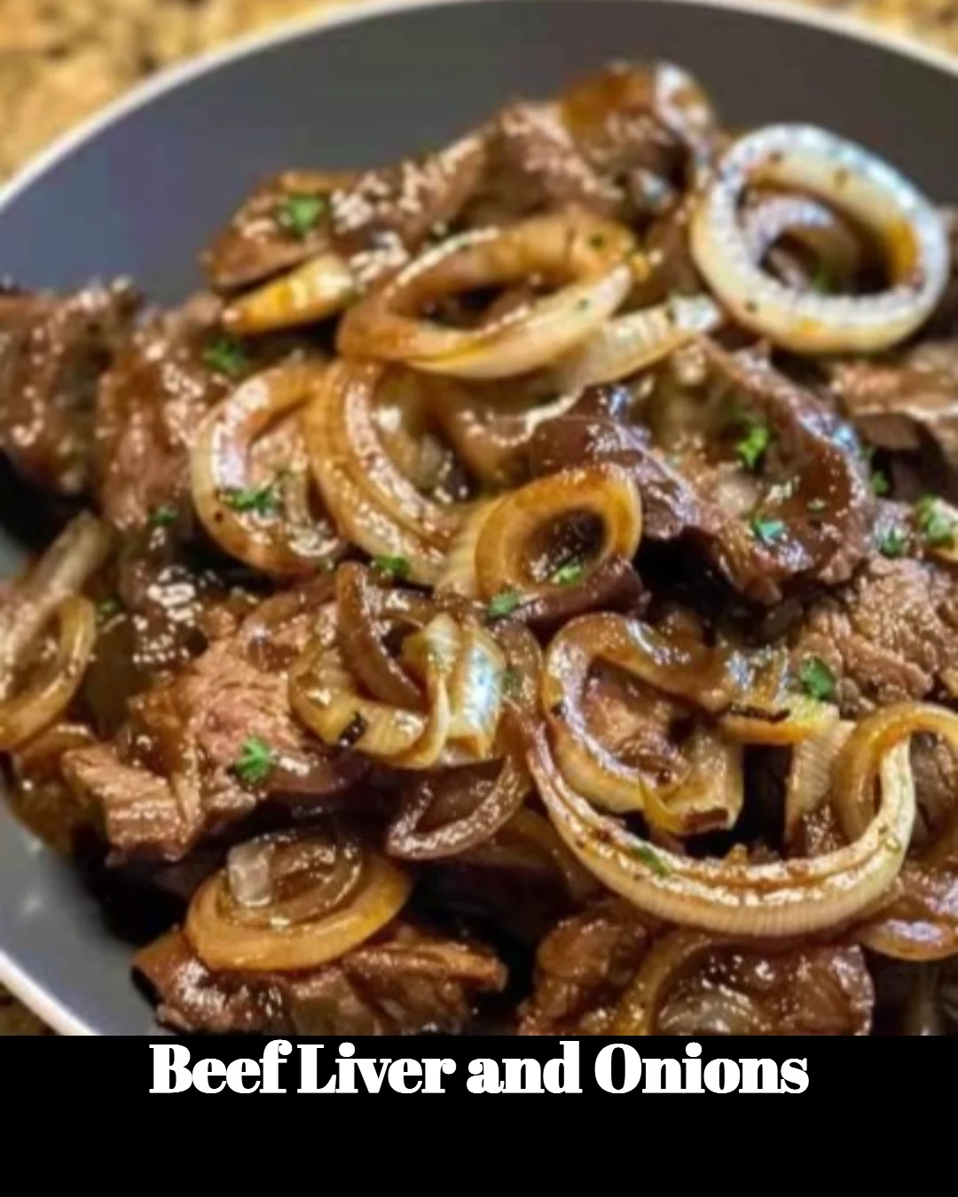 Plate of beef liver cooked with onions, garnished and ready to serve