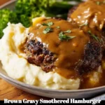 Brown gravy smothered hamburger steak served on a plate
