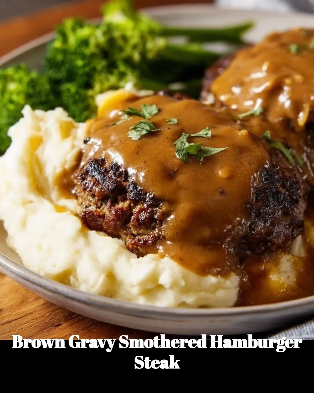 Brown gravy smothered hamburger steak served on a plate