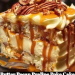Delicious Butter Pecan Praline Poke Cake topped with pecans and caramel drizzle