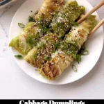 Plate of delicious homemade cabbage dumplings served with sauce.