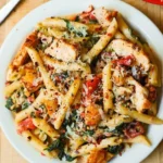 Delicious chicken pasta with herbs and sauce in a bowl