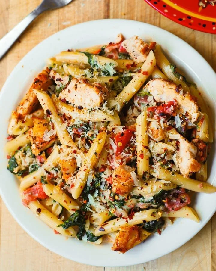 Delicious chicken pasta with herbs and sauce in a bowl