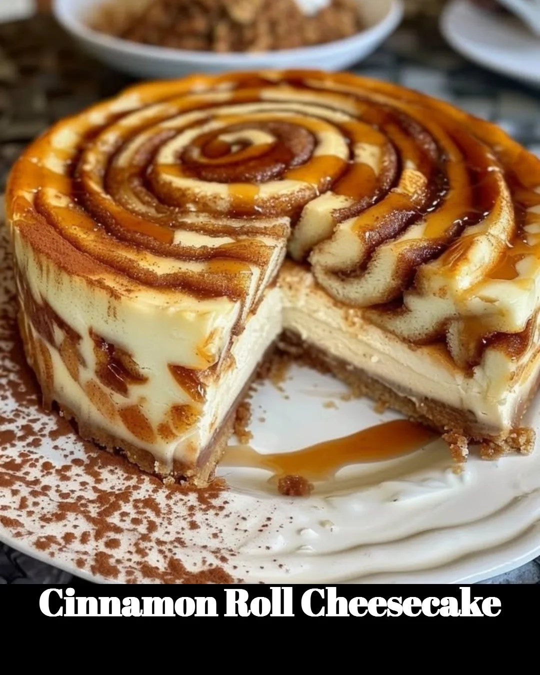 Delicious homemade Cinnamon Roll Cheesecake topped with cinnamon and cream.