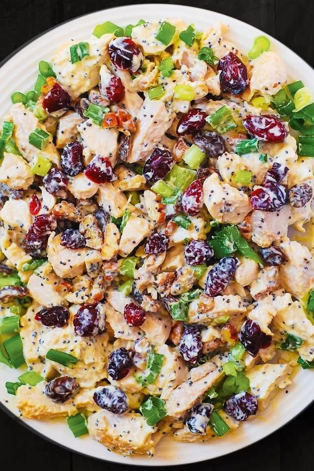 Cranberry Pecan Chicken Salad topped with poppy seed dressing in a bowl