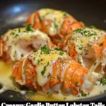 Delicious creamy garlic butter lobster tails served on a plate.