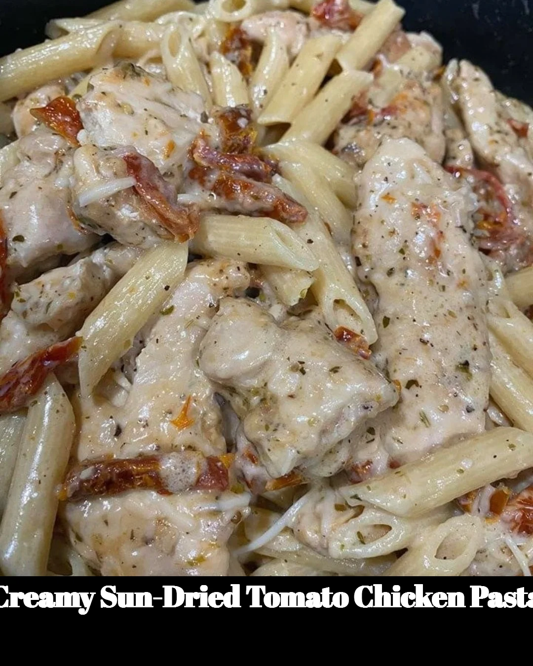Creamy sun-dried tomato chicken pasta garnished with basil