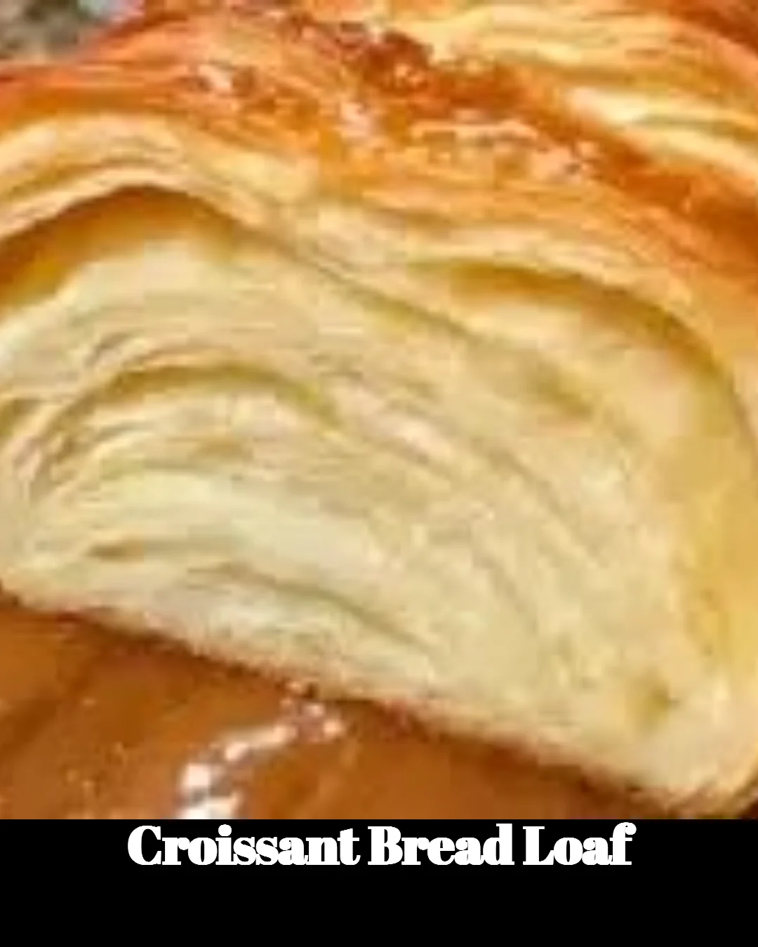 Freshly baked croissant bread loaf with a golden crust and flaky layers