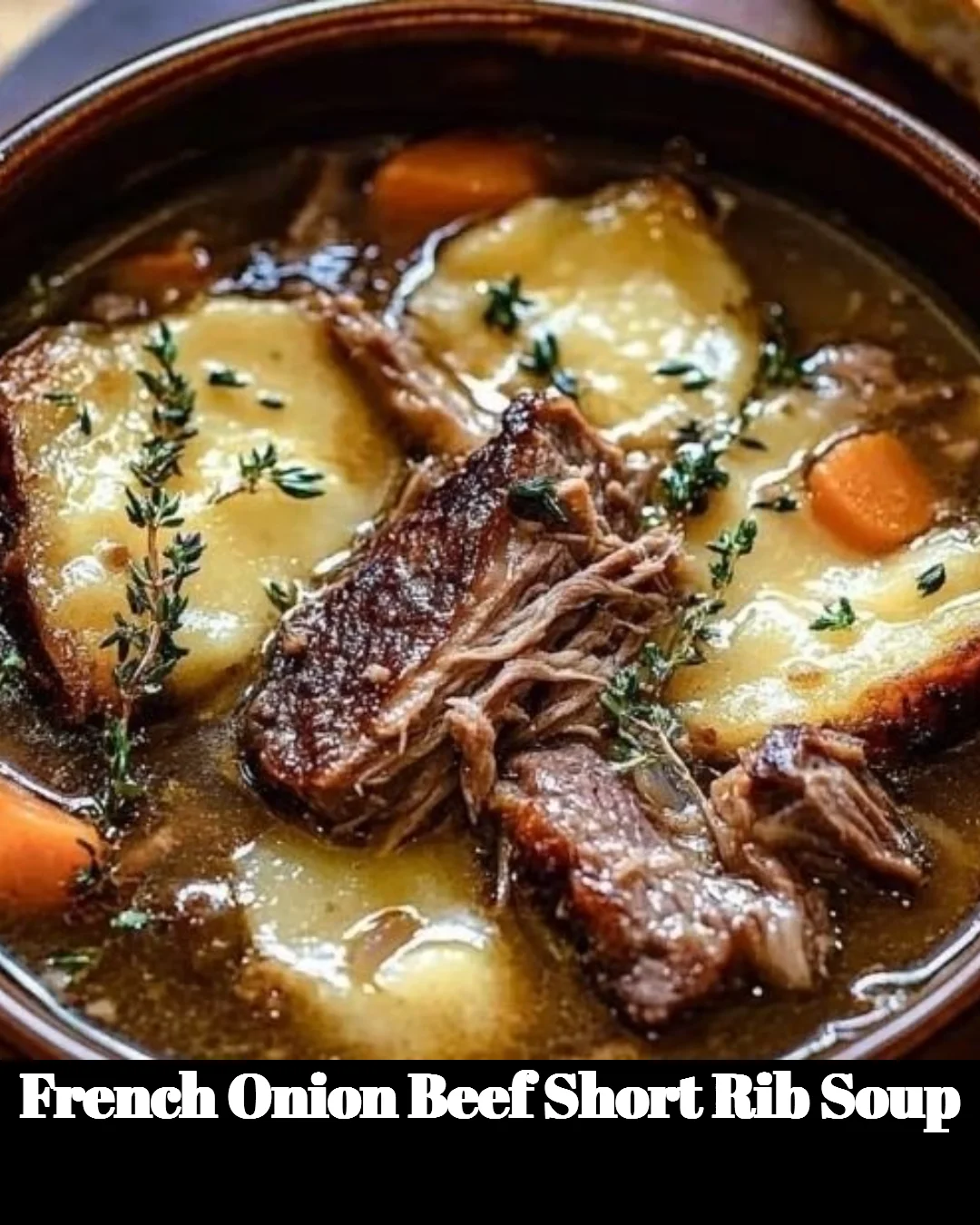 Bowl of French Onion Beef Short Rib Soup topped with melted cheese and herbs