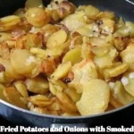Delicious plate of fried potatoes and onions served with smoked sausage