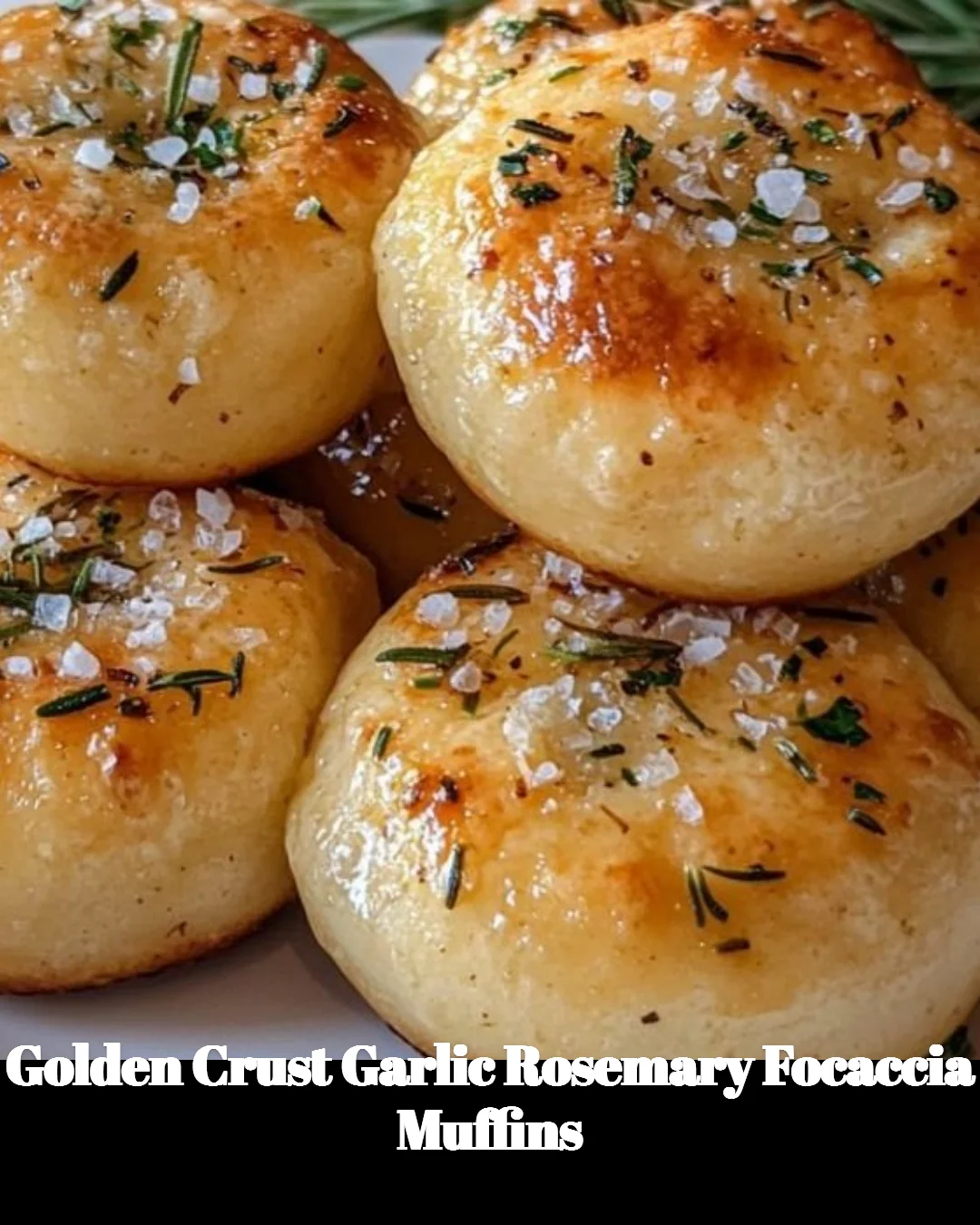 Golden crust garlic rosemary focaccia muffins on a wooden board