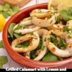 Delicious grilled calamari garnished with lemon and cilantro