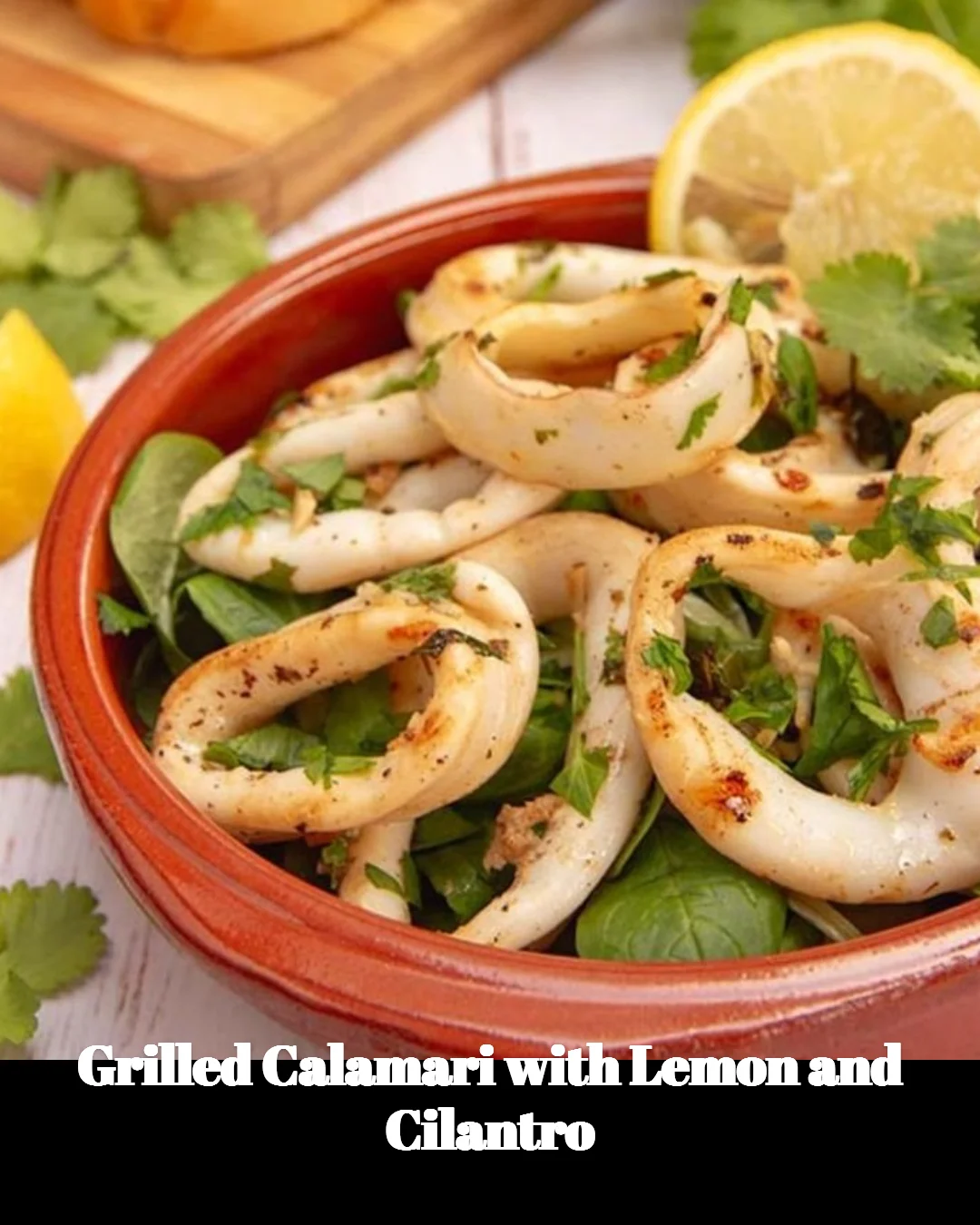 Delicious grilled calamari garnished with lemon and cilantro
