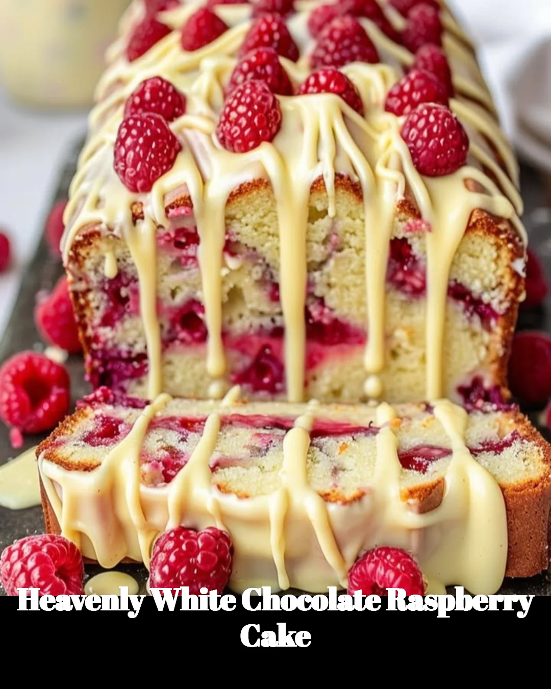 Heavenly white chocolate raspberry cake adorned with fresh raspberries.