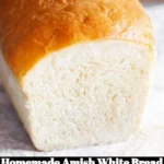 Loaf of homemade Amish white bread on a wooden cutting board