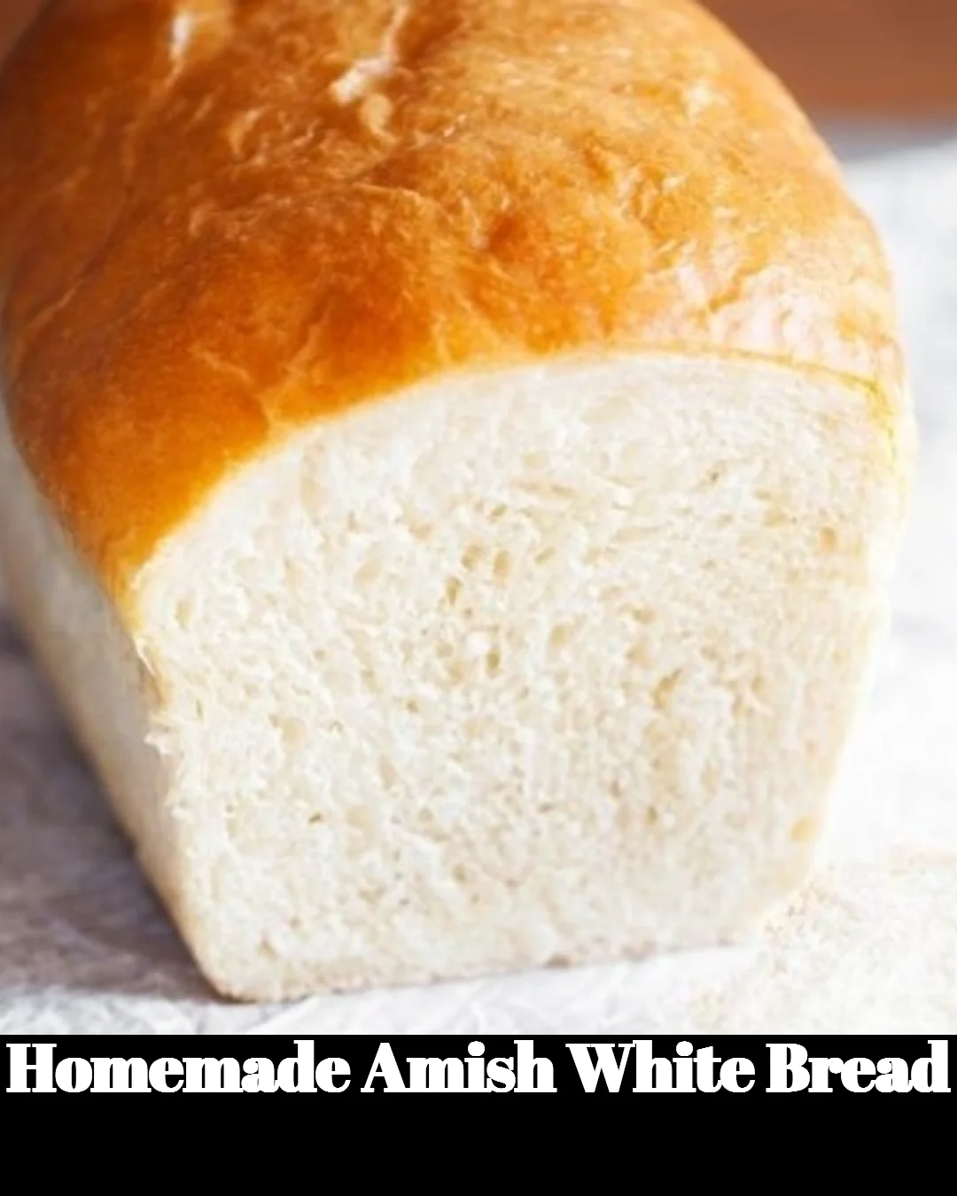 Loaf of homemade Amish white bread on a wooden cutting board