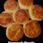 Flaky homemade biscuits on a wooden table ready to be served
