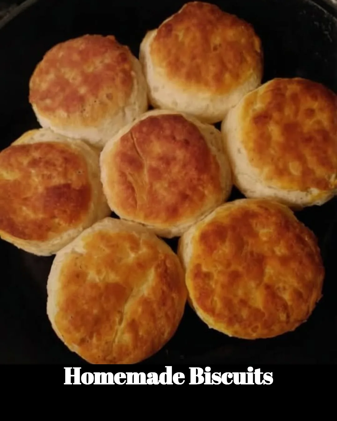 Flaky homemade biscuits on a wooden table ready to be served