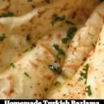 Freshly made homemade Turkish Bazlama flatbread on a wooden board