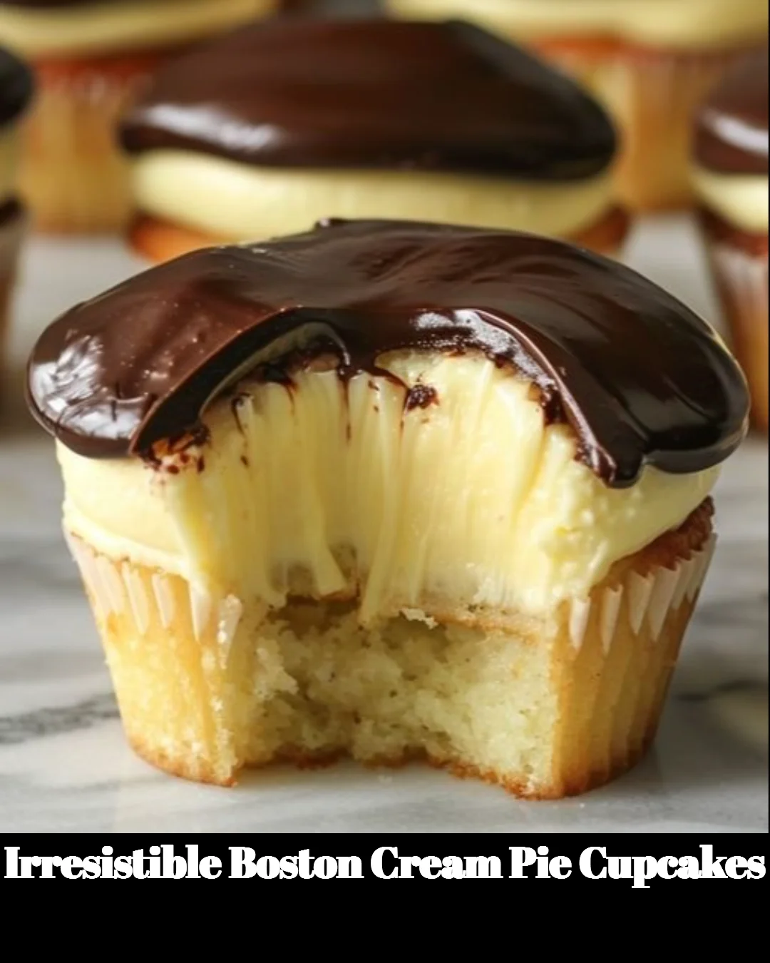 Delicious Boston Cream Pie Cupcakes topped with chocolate ganache and vanilla cream