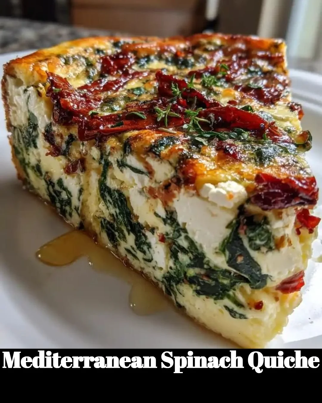 Slice of Mediterranean Spinach Quiche with fresh spinach and herbs