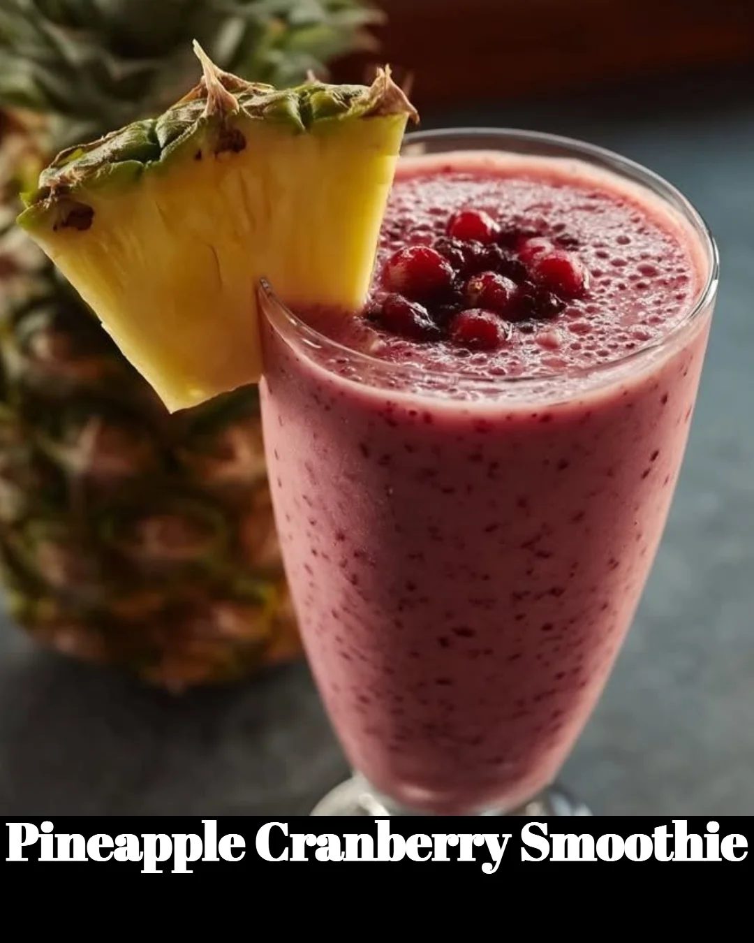 Delicious pineapple cranberry smoothie in a glass with fresh fruits