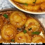 Plate of potato noodles and dumplings in savory sauce, garnished with herbs.